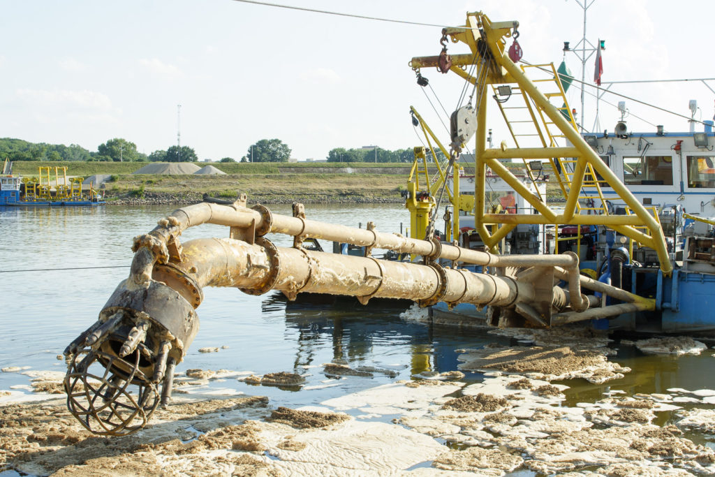 Color photo of suction dredge in muddy conditions