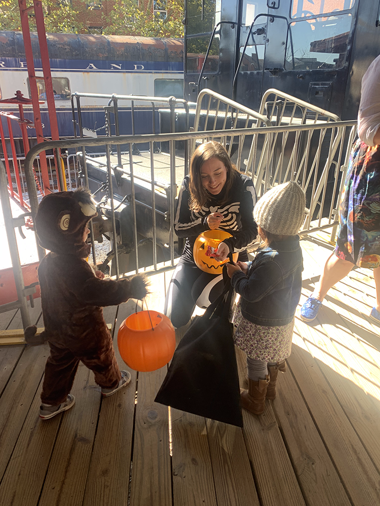 Northeast Maglev Communications Manager handing out candy to trick or treaters