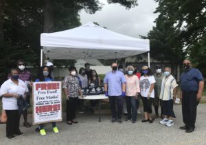 Photograph of Northeast Maglev employees and community leaders at a face mask distribution event