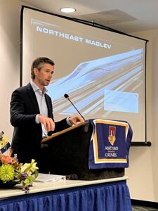 Photograph of Northeast Maglev Senior Vice President Ian Rainey presenting at the 2022 MACo Conference